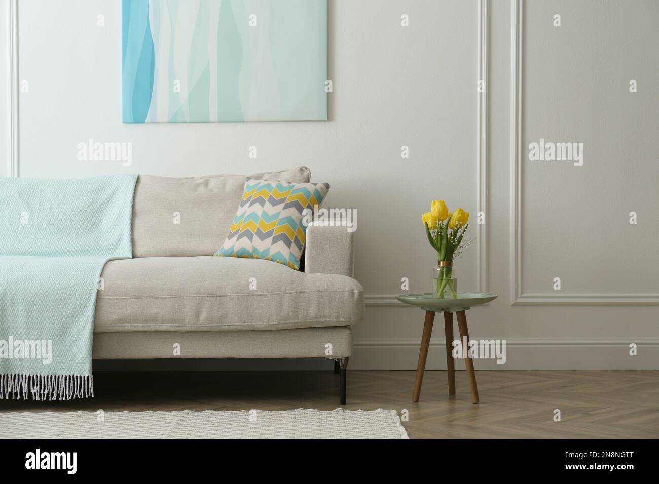 Stylish beige sofa in living room interior Stock Photo - Alamy